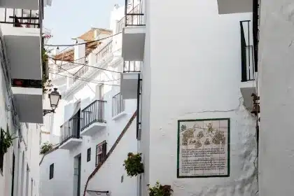 Manos anónimas sosteniendo pasaporte y formularios de registro consular