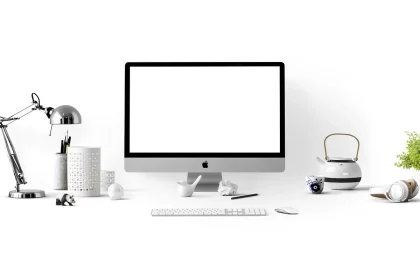 Mesa de redacción con monitor que muestra código HTML y manos tecleando
